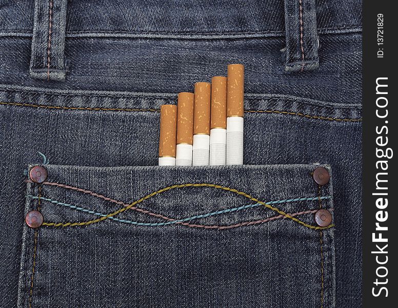 Close up of a blue jeans pocket with cigarettes coming out of it