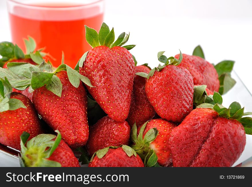 Strawberries and red glass of water. Strawberries and red glass of water