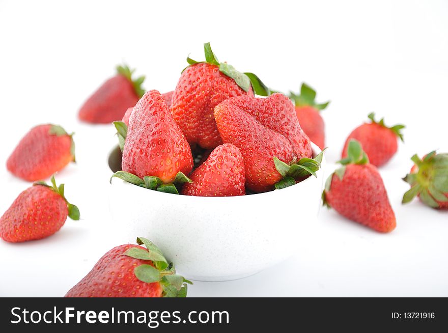 Red strawberries in bowl on table