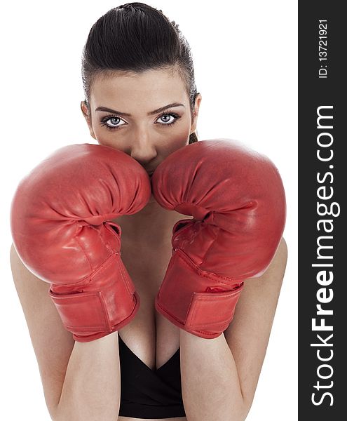 Woman covering her mouth with red gloves over white background