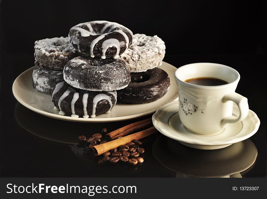 Cap of coffee with donuts on black background. Cap of coffee with donuts on black background