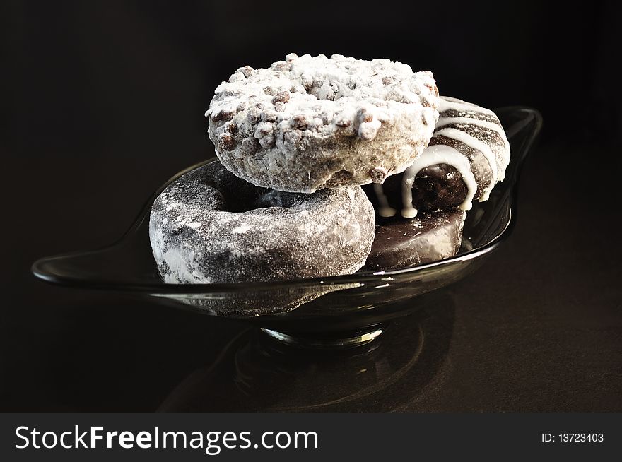 Chocolate donuts on black background