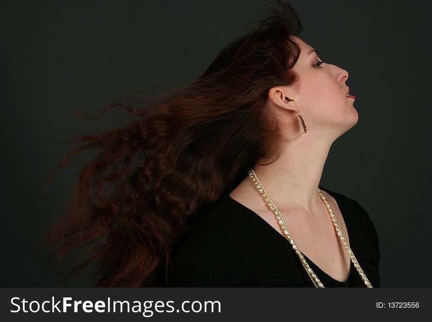 Portrait of young brunette woman isolated on black background