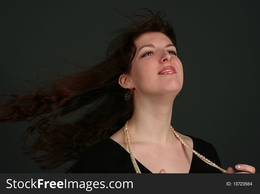 Portrait of young brunette woman isolated on black background