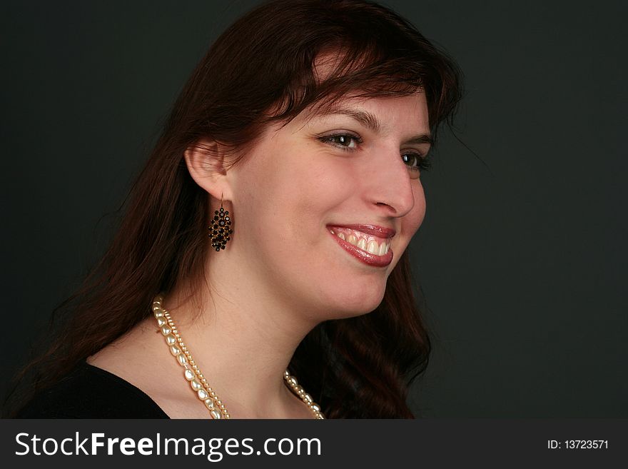 Portrait of young brunette woman isolated on black background