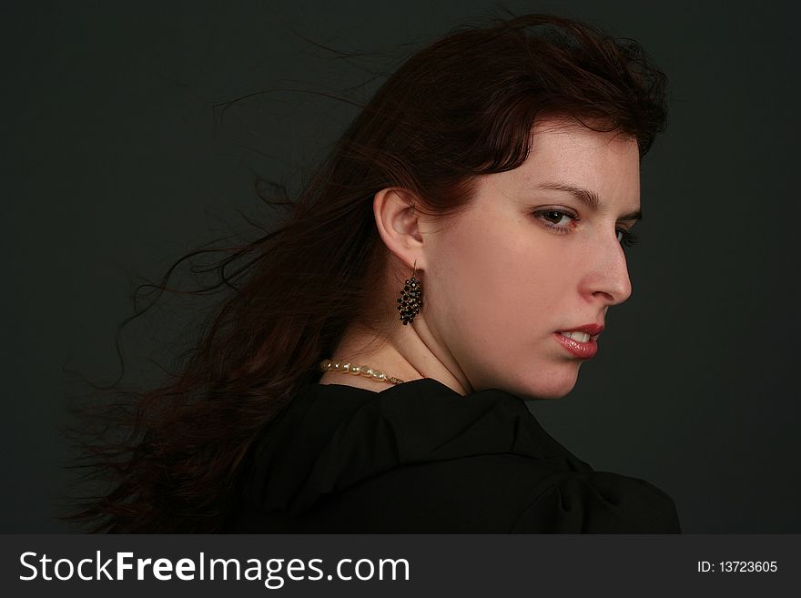 Portrait of young brunette woman isolated on black background