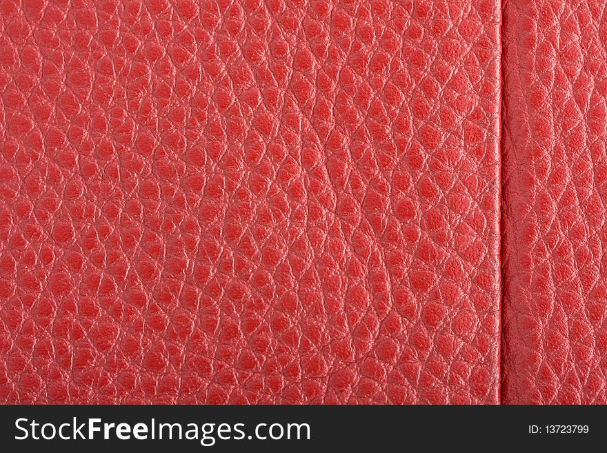 Fawn leather with red stitching. Close-up.