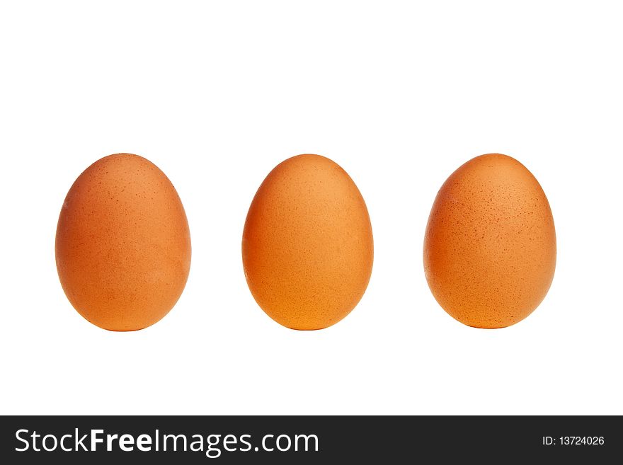 Three brown eggs in vertical position isolated over white background. Three brown eggs in vertical position isolated over white background.