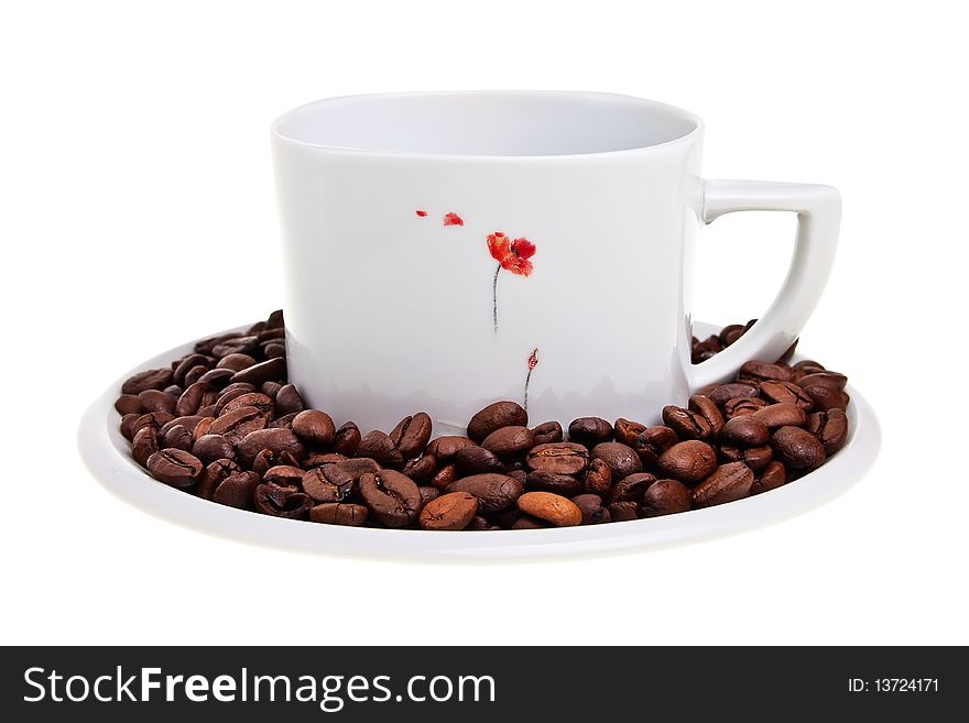 White cup with coffee beans on saucer isolated over white background. White cup with coffee beans on saucer isolated over white background.