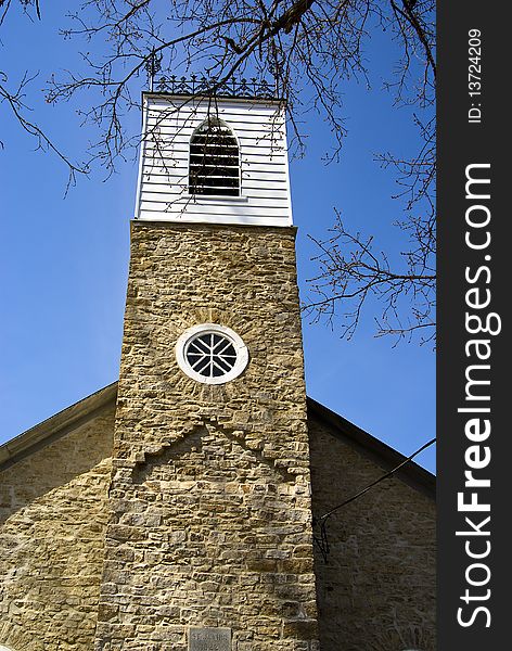 Close up of the steeple on a very old, country stone church. Close up of the steeple on a very old, country stone church.