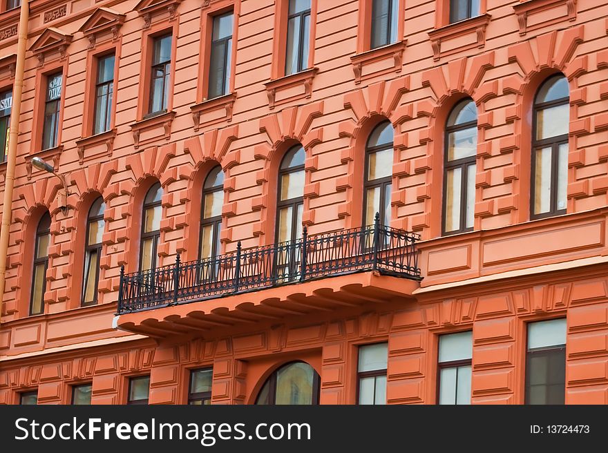 Facade of red building with balcony