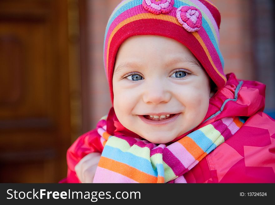 Portrait of smiling beautiful child in stripe cap