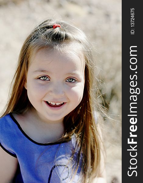 Happy, smiling girl portrait in the summertime with a desert background.  NOTE: The unusual, ghostly color of the face is because of the watermark. Happy, smiling girl portrait in the summertime with a desert background.  NOTE: The unusual, ghostly color of the face is because of the watermark.