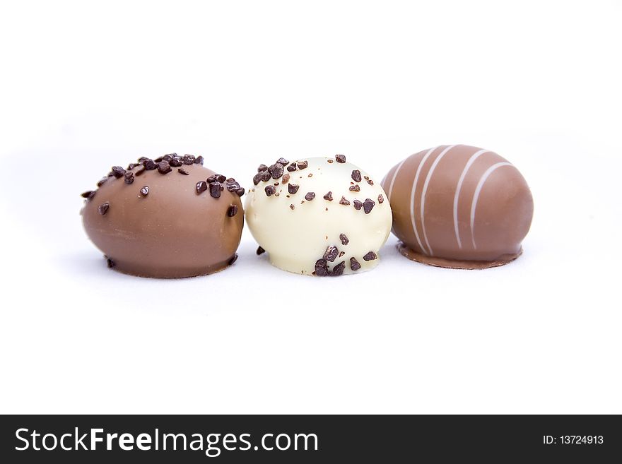 Three chocolate truffle eggs isolated on a white background