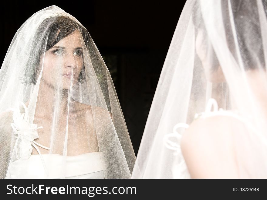 Beautiful brunette bride with short hair and white gown