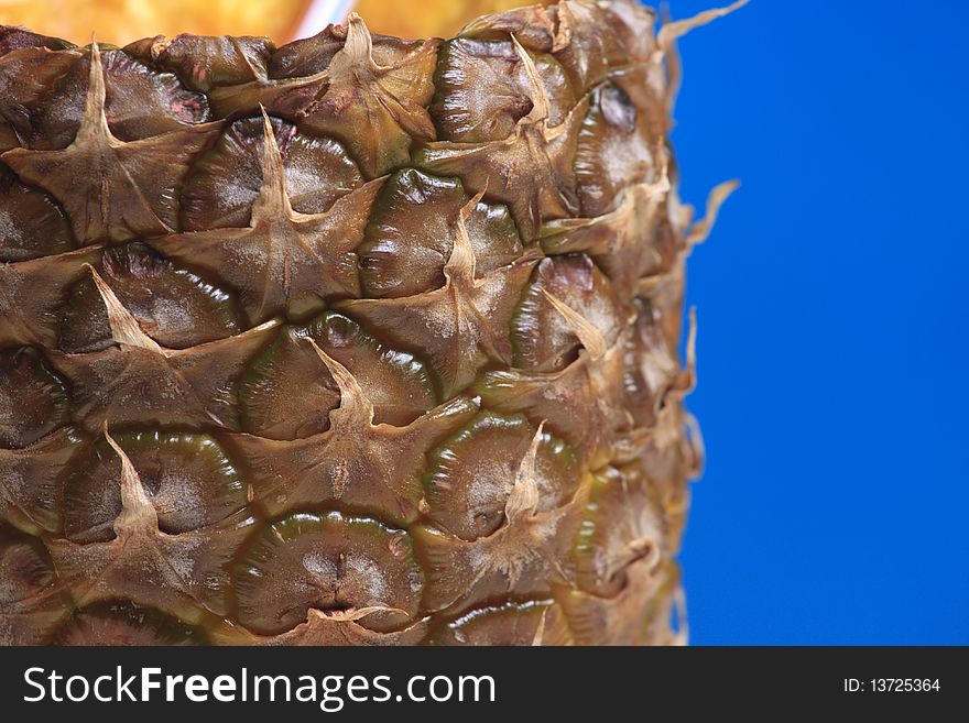 Abstract pineapple texture close up macro photo on sky blue. Focus on a forward plane of pineapple