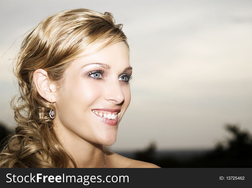 Beautiful Blond bride with blue eyes wearing diamond jewelery