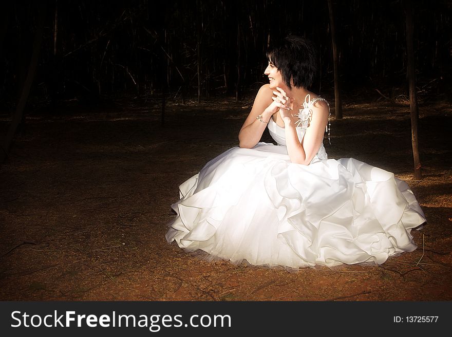 Beautiful brunette bride with short hair and white gown