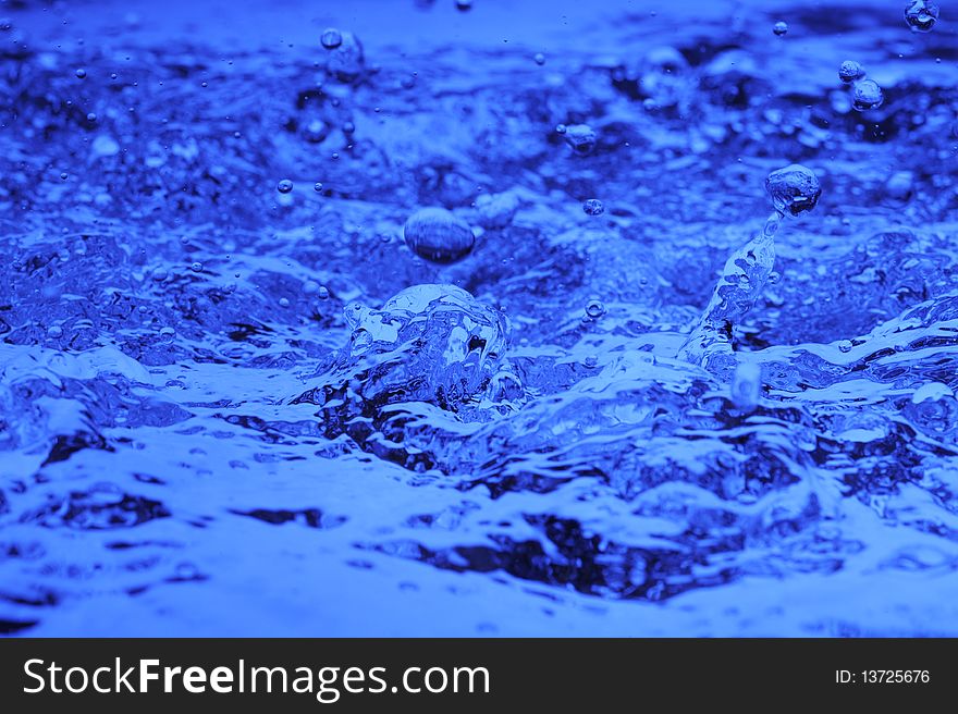 Background with blue water. Creative splashing