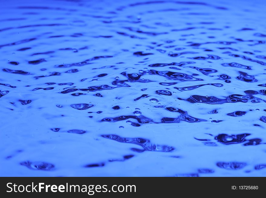Background with blue water. Creative splashing