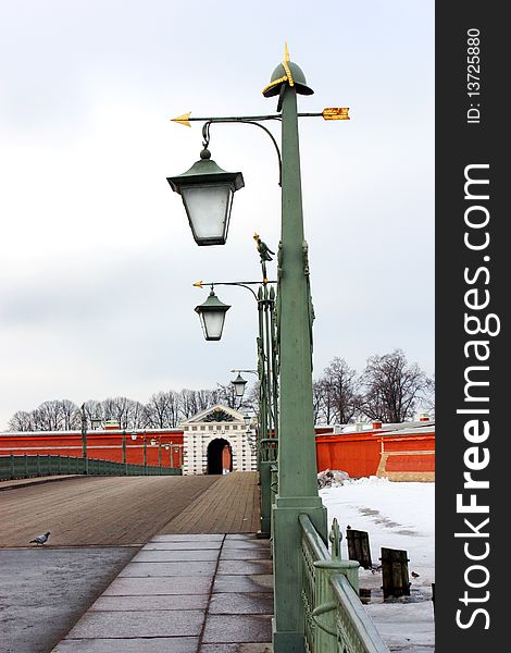 Peter and Paul Fortress, the bridge with lights, a fence on the bridge, dove, the entrance to krepos, the gate to the fortress, a symbol of Russia, a symbol of St. Petersburg