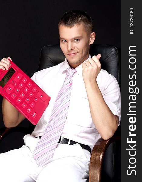 Handsome businessman with red calculator. Handsome businessman with red calculator