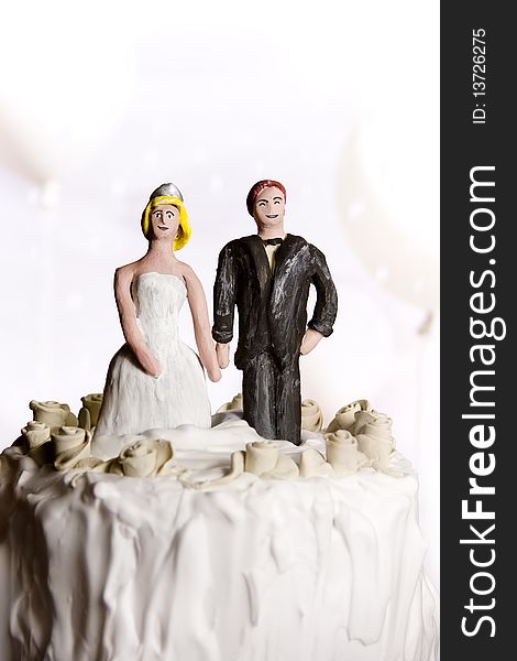 Figurines on top of wedding cake. Copy space. Figurines on top of wedding cake. Copy space