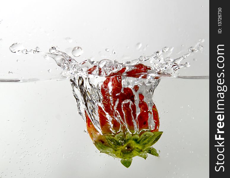 A close-up shot of strawberry splash in water
