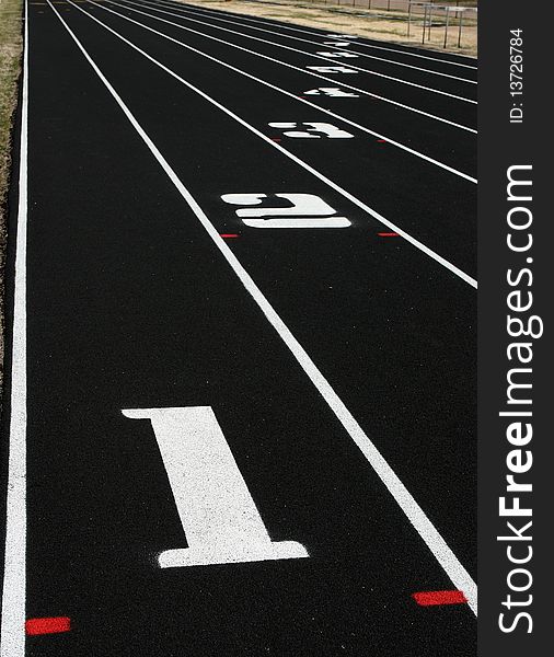 Vertical view of lanes 1 through 8 on school track field. Vertical view of lanes 1 through 8 on school track field.