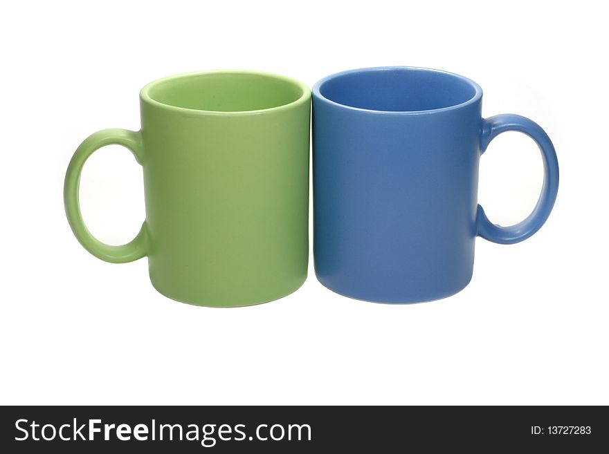 Green and blue cups isolated over white