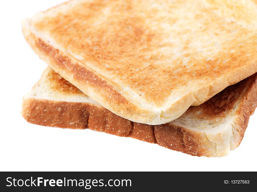 Two pieces of baked bread isolated on white background. Two pieces of baked bread isolated on white background.