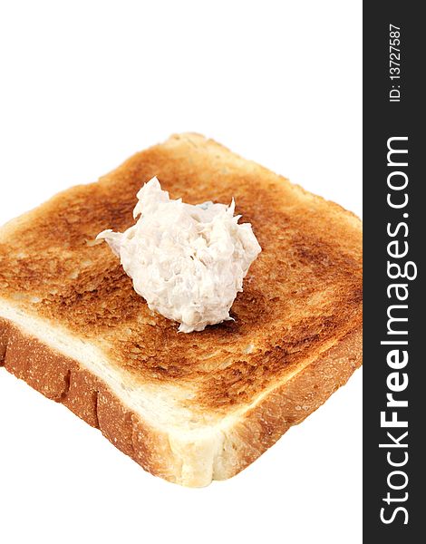 A piece of baked bread with mayonnaise tuna isolated on white background. A piece of baked bread with mayonnaise tuna isolated on white background.