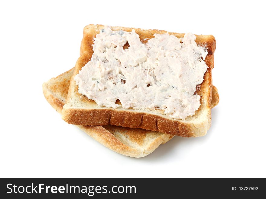 A piece of baked bread with mayonnaise tuna isolated on white background. A piece of baked bread with mayonnaise tuna isolated on white background.