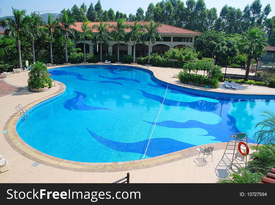 Sunny summer day large swimming pool in the hotel.