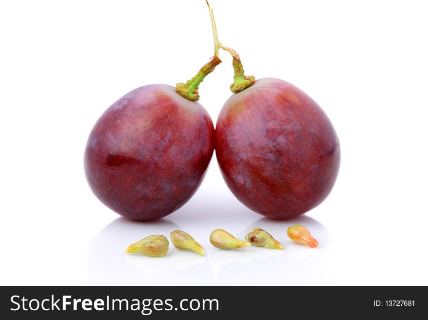 An half and fullness grapes with seeds isolated over white background.