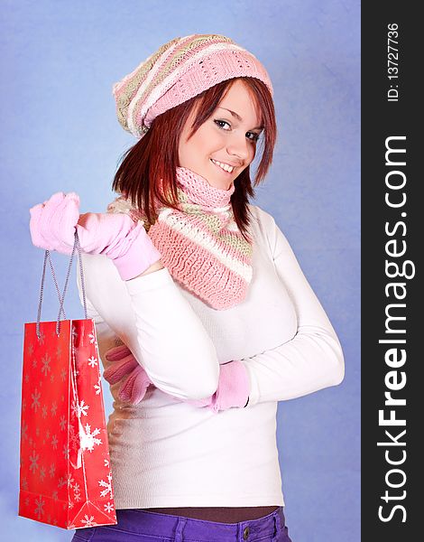 Beautiful young girl holding a red shopping paper bag. Beautiful young girl holding a red shopping paper bag