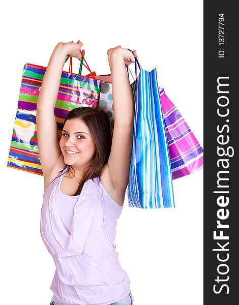 Beautiful young woman standing and holding colorful paper bags. Beautiful young woman standing and holding colorful paper bags