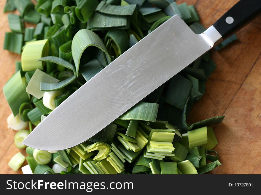 Sliced scallion and knife in kitchen. Sliced scallion and knife in kitchen