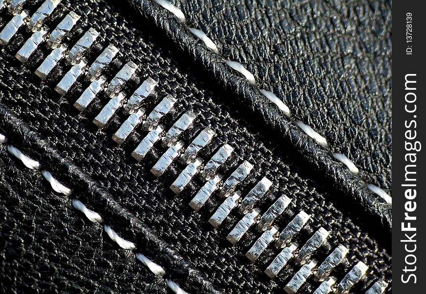 Silver zipper on black leather