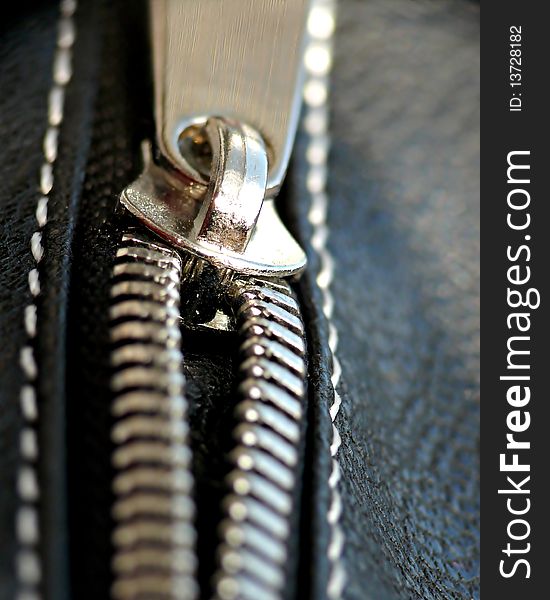 Silver zipper on black leather. Silver zipper on black leather