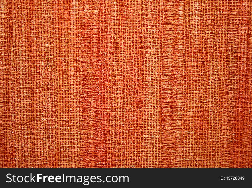 Texture of coarse cloth, orange-colored interlocking fibers
