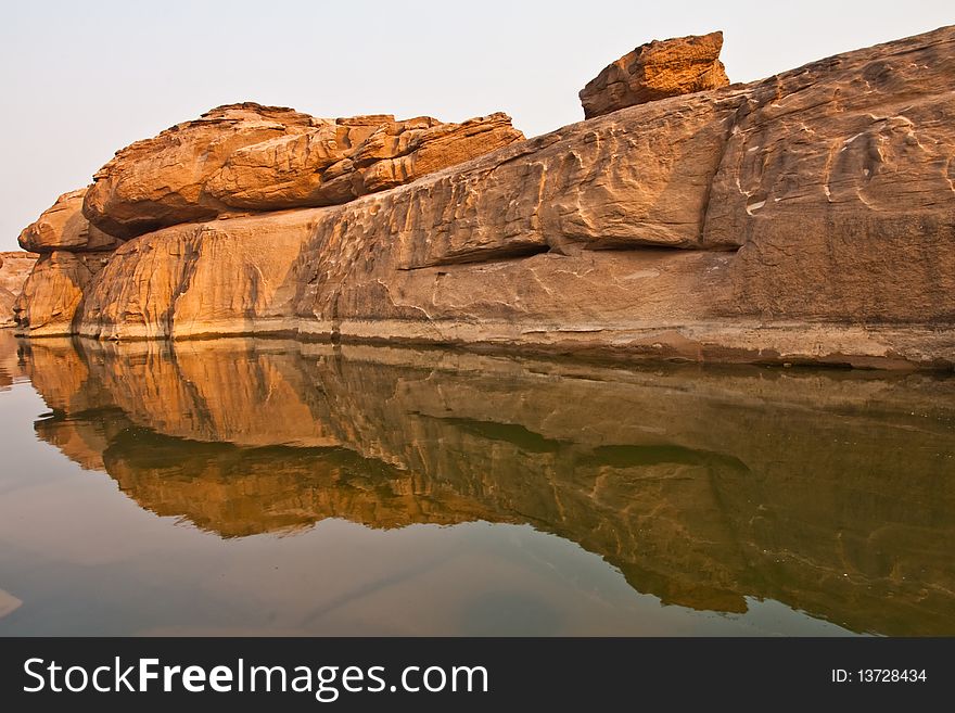 Rock And Reflection In Clear Water