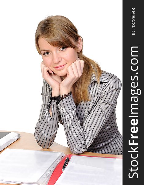 Portrait of the thinking young woman  with a folder sitting at a table on a white background. Portrait of the thinking young woman  with a folder sitting at a table on a white background