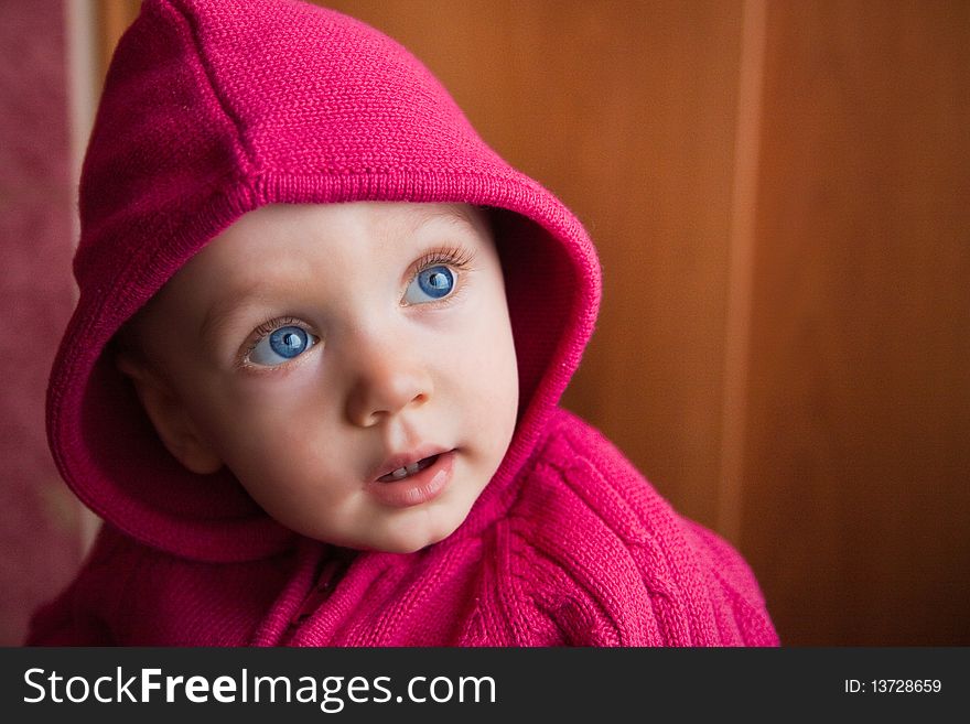 Portrait of amazed beautiful child in stripe cap