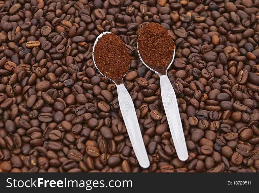 Coffee grains with two spoon with coffee