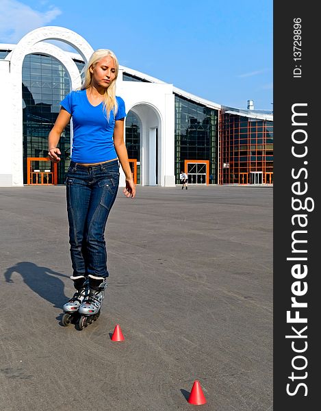 Young blonde woman rolling on the street. Young blonde woman rolling on the street