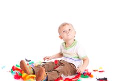 Little Boy Is Sitting On A Flow With Feathers Stock Photography Little Boy Is Sitting On A Flow With Feathers Stock Photography