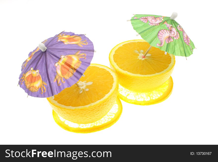 Ripe oranges and parasols on a white background
