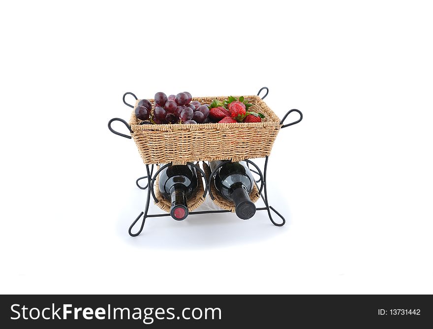 Bottle of vine with fruits in straw basket. Bottle of vine with fruits in straw basket