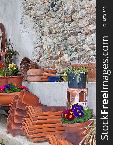 Garden detail: tools, tiles, pots and flowers